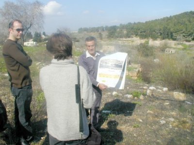 Internally displaced from Safuriya , Abu Arab holds a pre-1948 photo of his toen with the JNF forest that has erplaced in the Background 
