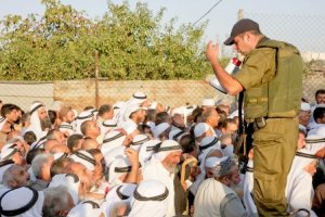 At the Israeli Military checkpoint Between Bethlehem and Jerusalem, August. 2011 (photo source: ActivStills.com)