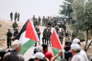 Palestinians and International Solidarity members during the weekly protest against the Apartheid Wall on the land of Ni'lin, Ramallah, West Bank. October 2009 (photo: Hindi Musleh/BADIL)